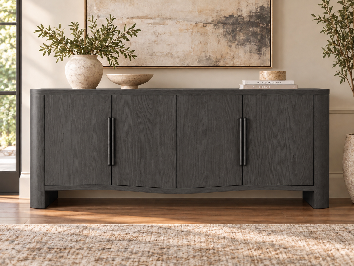 Norwick Elara Black Charcoal sideboard with four closed doors and vertical handles, shown in a staged room